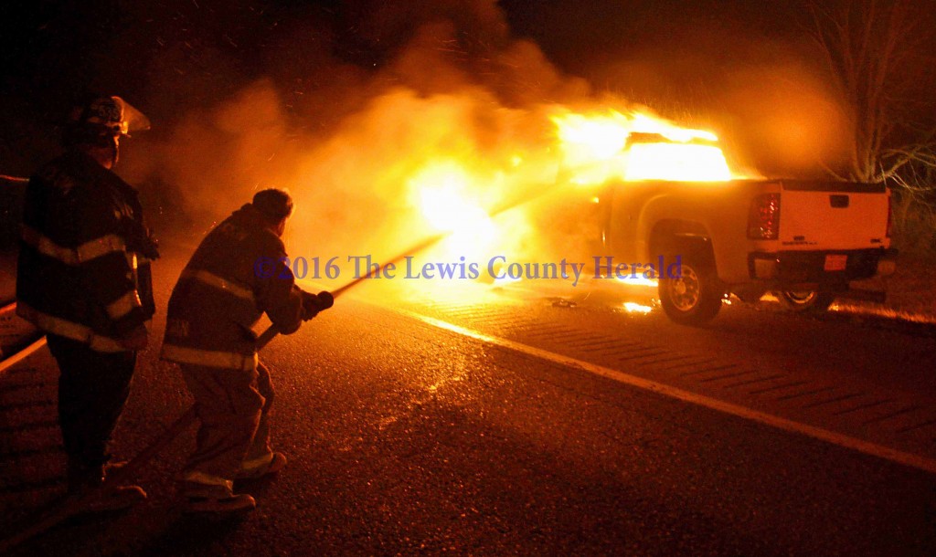 Firefighters work to extinguish a vehicle fire on the AA Highway at Garrison. - Photo by Dennis Brown