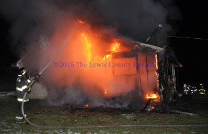 Firefighers battle a house fire in Garrison. - Photo by Dennis Brown