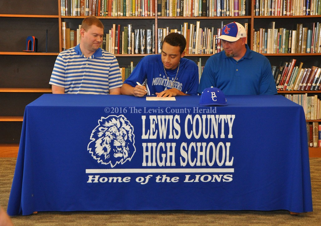 Jalen Prater signs a letter of intent with the Berea College Mountaineers as LCHS Assistant AD Josh Hughes and Baseball Coach David Kelley look on. - Photo by Dennis Brown