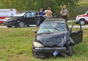 Deputy Matt Ross photographs an accident scene Thursday afternoon on Ky. Rt. 344. - Photo by Dennis Brown