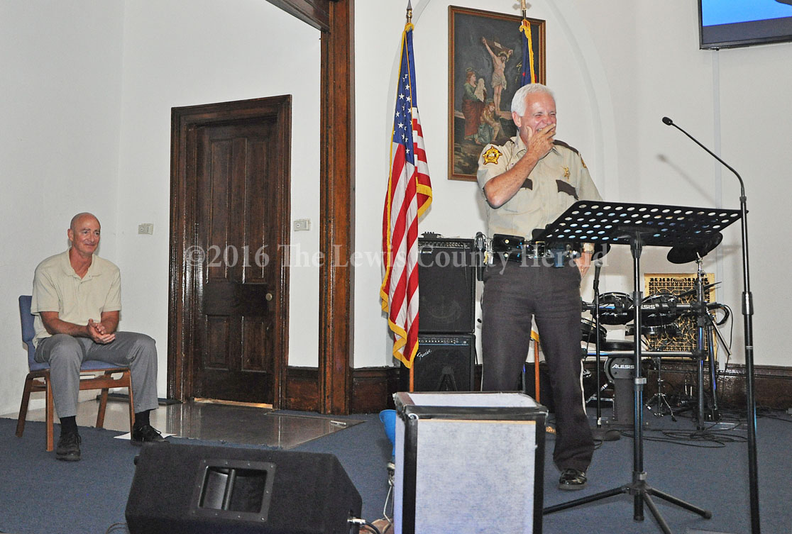 Deputy John Byard reacts after telling a story about Vanceburg Christain Church Pastor Tom Cox (at left). Byard officiated the wedding ceremony for Tom and Karen Cox. - Photo by Dennis Brown