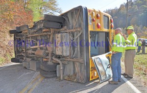 Workers with the Kentucky Department of Transportation examine a school bus following an accident Wednesday afternoon on Ky. Rt. 59 south of Vanceburg. - Dennis Brown Photo