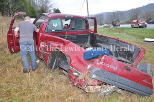 Deputy Eric Poynter examines the scene of a single vehicle accident that injured a Vanceburg teen. - Dennis Brown photo
