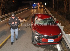 Deputy Gary Erwin examines the scene of an accident early Sunday on Ky. Rt. 8 at Quincy. - Dennis Brown Photo