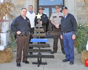 A Thin Blue Line Christmas tree is presented to local law enforcement by Danny Rowe. Pictured, left to right, are Sheriff Johnny Bivens, Judge Executive Todd Ruckel, Deputy Teresa Lewis, Deputy Matt Ross and Danny Rowe. - Dennis Brown Photo