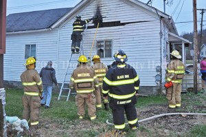 Firefighters work to contain a fire at a Vanceburg home on Monday. - Dennis Brown Photo