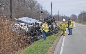 Firefighters examine the scene of a tanker truck accident Thursday afternoon on Ky. Rt. 8 just east of Quincy. The accident resulted in some evacuations and the road closure. - Dennis Brown Photo
