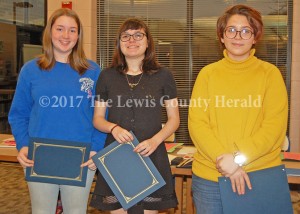 These LCHS students were recognized for their accomplishments during a meeting of the Lewis County Board of Education Monday. Pictured, left to right, are Sarah Walker, Katelyn Carver and Hope Lewis. Each was named a grade-level winner in the annual Ohio River Sweep poster contest. - Dennis Brown Photo