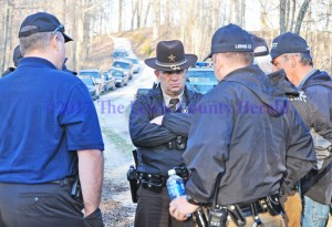 Sheriff Johnny Bivens talks with deputies and other investigators on Cooper Ridge at the Lewis/Carter county line near where Justin Johnson's body was discovered. - Dennis Brown Photo