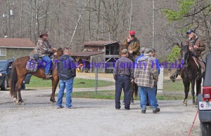 Sheriff Johnny Bivens, standing at left, talks with volunteers on horseback near the location where Justin Johnson's abandoned truck was found. - Dennis Brown Photo