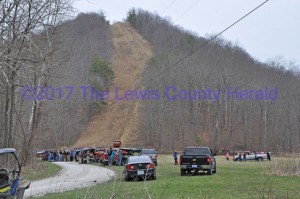 Several volunteers, family members, and search crews on Saturday afternoon where missing Vanceburg man's truck was found. (The red pick-up is visible at the base of the hill on a gas pipeline right-of-way.) - Dennis Brown Photo