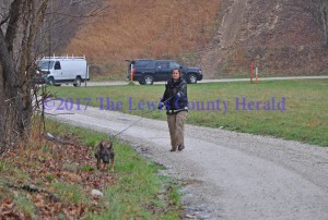 A K-9 search team with Kentucky Search Dog Association assists in the search for a missing Vanceburg man Sunday morning near where his pick-up was discovered. - Dennis Brown Photo