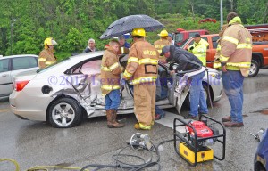 Rescue workers tend to an elderly couple following an accident in Vanceburg Tuesday afternoon. Both were taken to the hospital. - Dennis Brown Photo