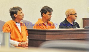 Preston Neill Walters, left, and Wince Walters sit with Lewis County Jailer Jeff Lykins as they wait for their appearance in Lewis District Court. - Dennis Brown Photo
