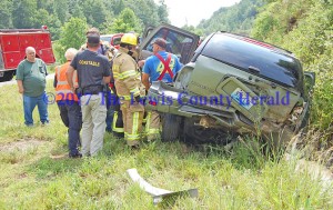 Rescue workers tend to an injured person following a crash on the AA Highway east of Vanceburg on Friday afternoon. - Dennis Brown Photo