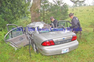 Deputy Gary Sparks and Deputy Matt Ross collect information at the scene of a single-vehicle accident on the AA Highway near Tollesboro. - Dennis Brown Photo