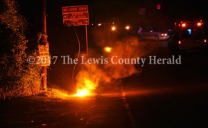 A live electric line fell to the ground as the result of a single vehicle accident on Main Street in Vanceburg late Saturday. The line arced for several minutes and power was disrupted for several Vanceburg residents. - Dennis Brown Photo