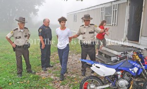 Officers arrest a suspect during Operation Fall Harvest on Friday. The roundup was a joint effort with the Lewis County Sheriff's Office and Vanceburg Police Department. - Dennis Brown Photo
