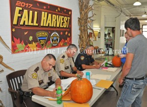Officials process suspects during a drug roundup Friday. Pictured, left to right, are Sheriff Johnny Bivens, Deputy Bryon Walker, and Vanceburg Police Chief Joe Billman. - Dennis Brown Photo
