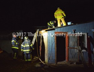 Firefighters ensure a fire at a home on Trace Creek Road has been extinguished. - Dennis Brown Photo