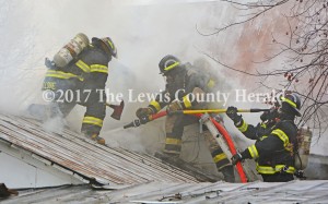 Firefighters work to bring a fire under control on Happy Hollow Road Wednesday morning. No one was hurt although the home sustained extensive damage. - Dennis Brown Photo