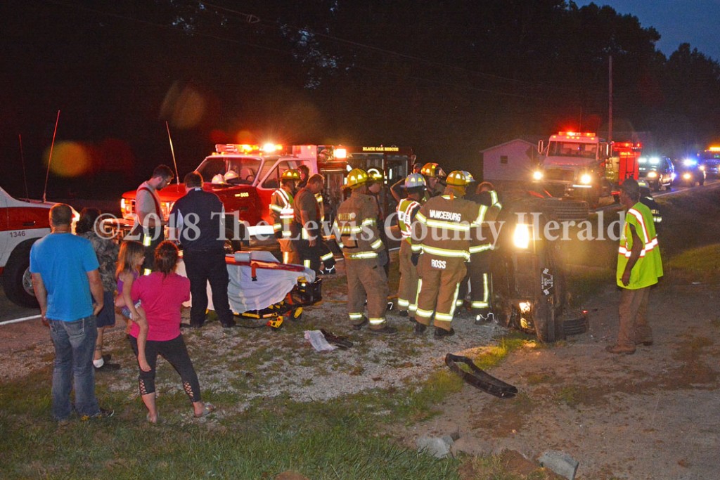 First responders work to remove the driver of an auto following an accident on Ky. Rt. 8 east of Vanceburg Saturday night. Roberta Colby, 25, of Garrison, was taken to the hospital for treatment of multiple injuries. - Dennis Brown Photo