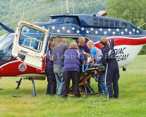 Emergency workers load a patient onto a medical helicopter following a motorbike crash on Quick's Run Road. - Dennis Brown Photo