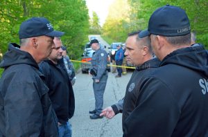 Sheriff Johnny Bivens talks with deputies at the location where human remains were discovered on Wednesday. The remains have been identified as those of a missing Vinton County, Ohio, man. - Dennis Brown Photo